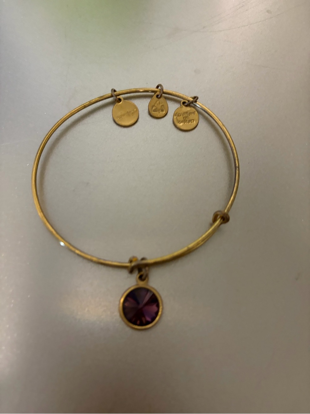 Gold-Tone Bangle Bracelet with Purple Crystal Charm
